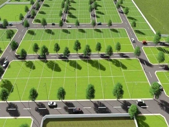 Aerial view of organized residential plots with greenery and roads at Vriddhi Homez.